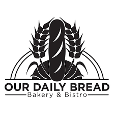 Black and white logo - Our Daily Bread written at the bottom with a load of bread and wheat with sun